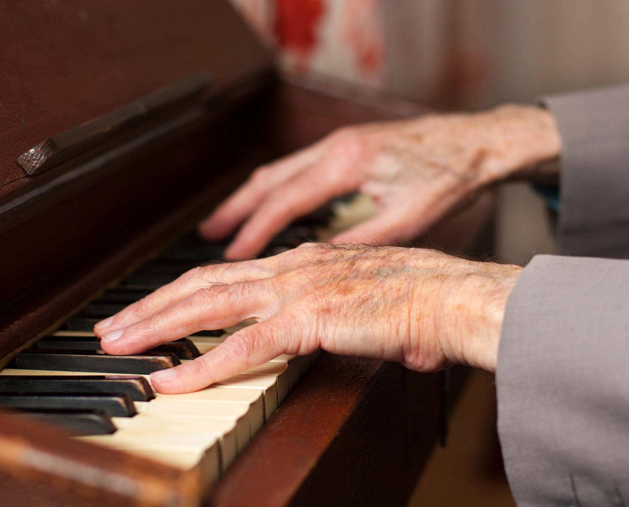 Elferly male playing piano
